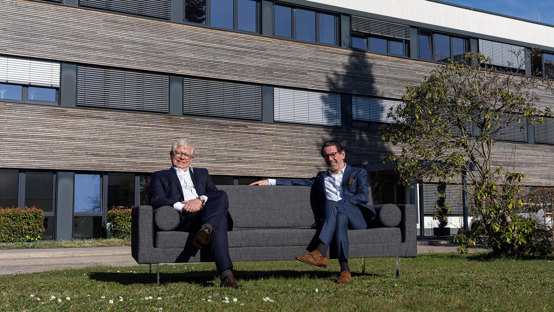 Geschäftsführung von Faller Packaging sitz im Grünen vor dem Hauptsitz in Waldkirch