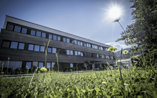 Headquarters of Faller Packaging in Waldkirch featuring modern industrial architecture and a green foreground