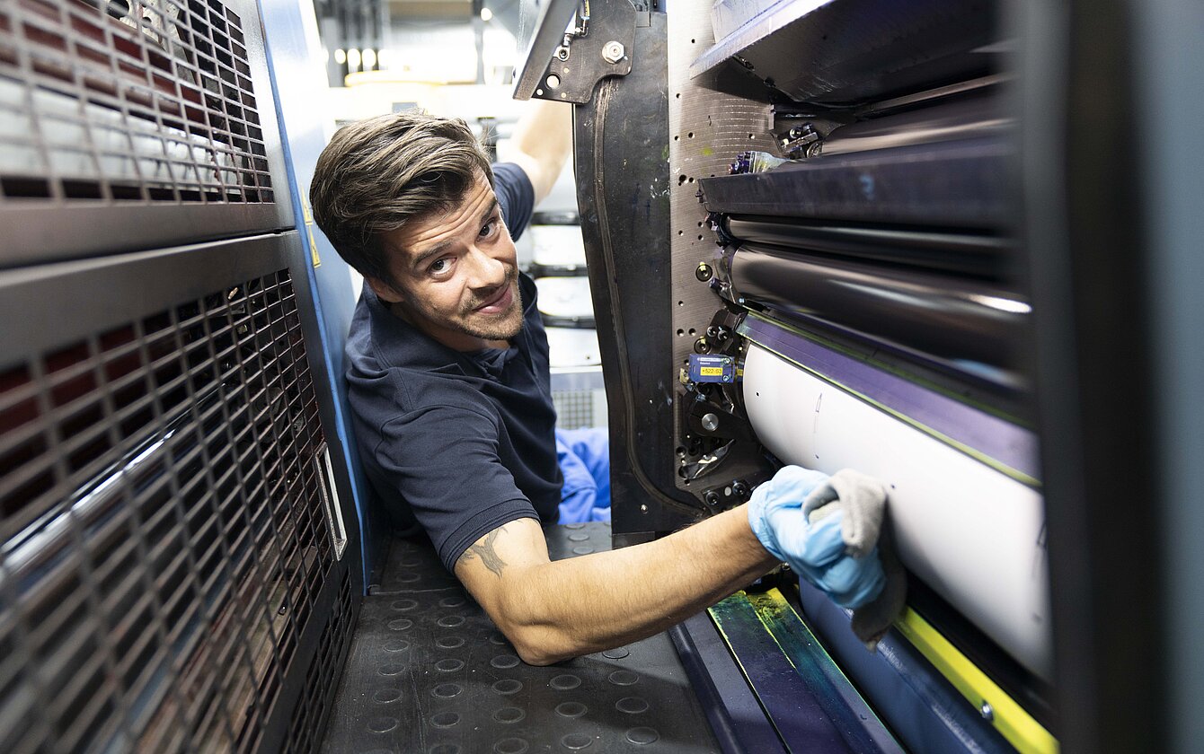 Emballageteknolog justerer blæk i trykmaskinen